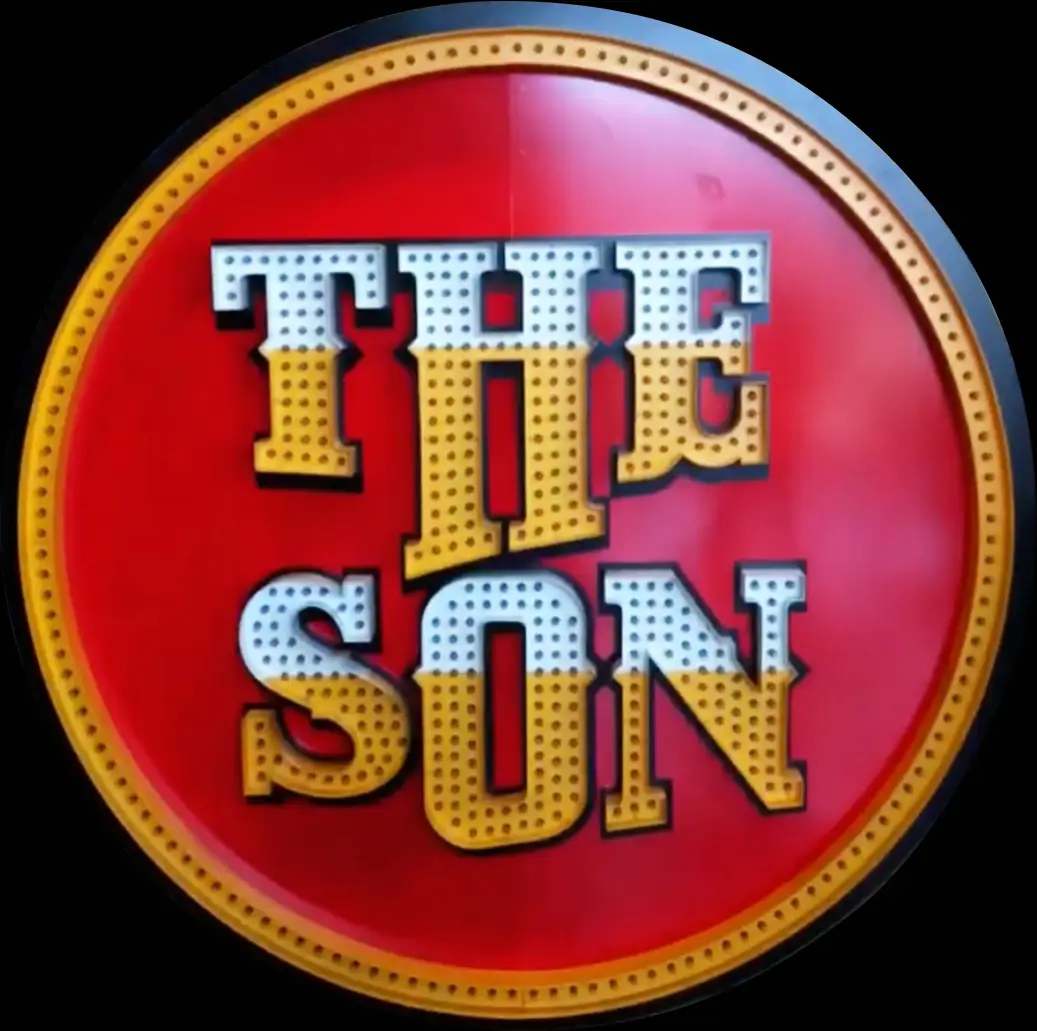 The hand-painted THE SON sign standing at the farm entrance
